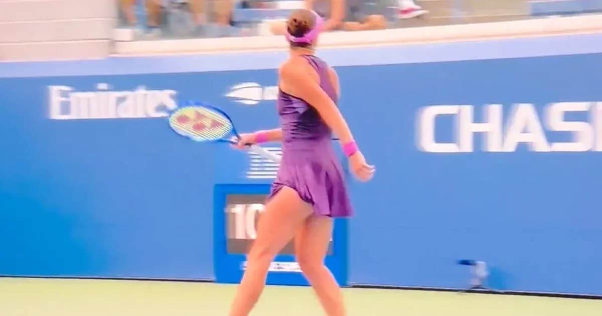 Female tennis player preparing to serve on court