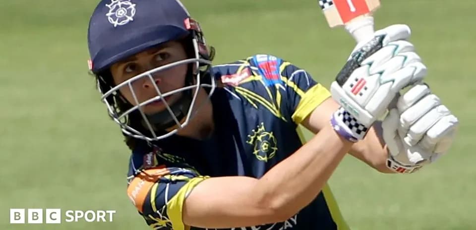 Cricketer batting during a match on the field