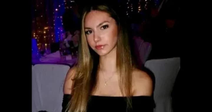 Young woman sitting at a table in a dimly lit venue