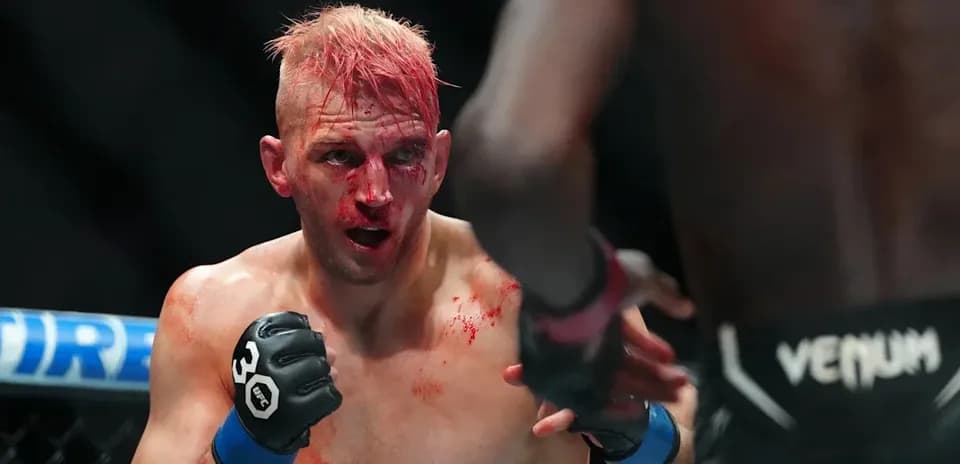 Fighter with blood on face during MMA match