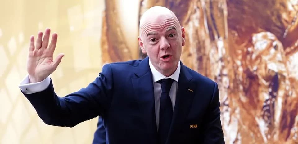FIFA official speaking with raised hand at event
