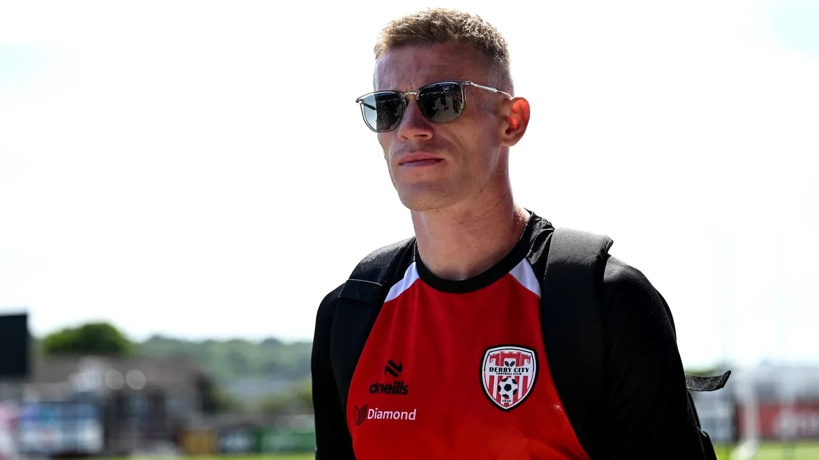 Player wearing sunglasses in Derry City jersey