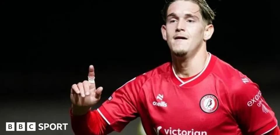 Player celebrating with finger raised in red jersey
