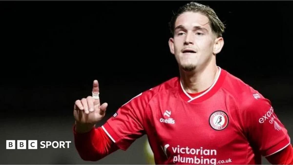 Player celebrating with finger raised in red jersey