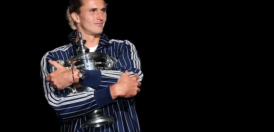 Player holding trophy in dark background