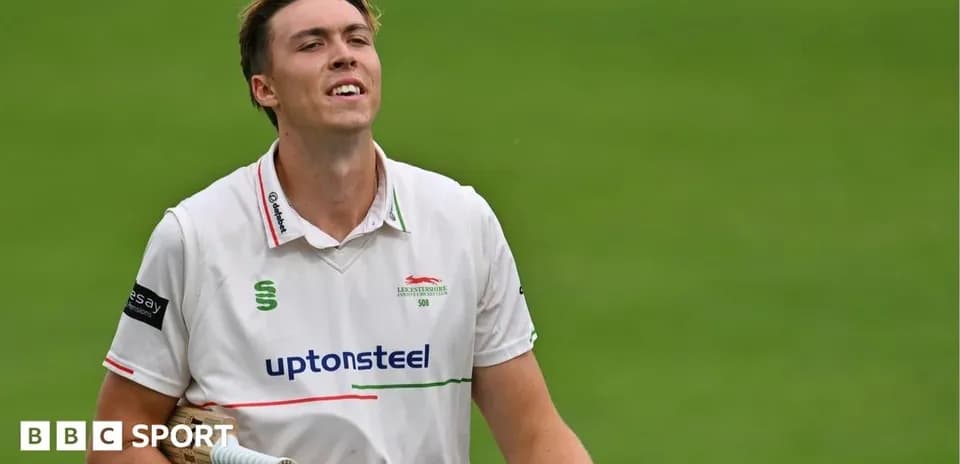 Cricketer walking off the field after innings