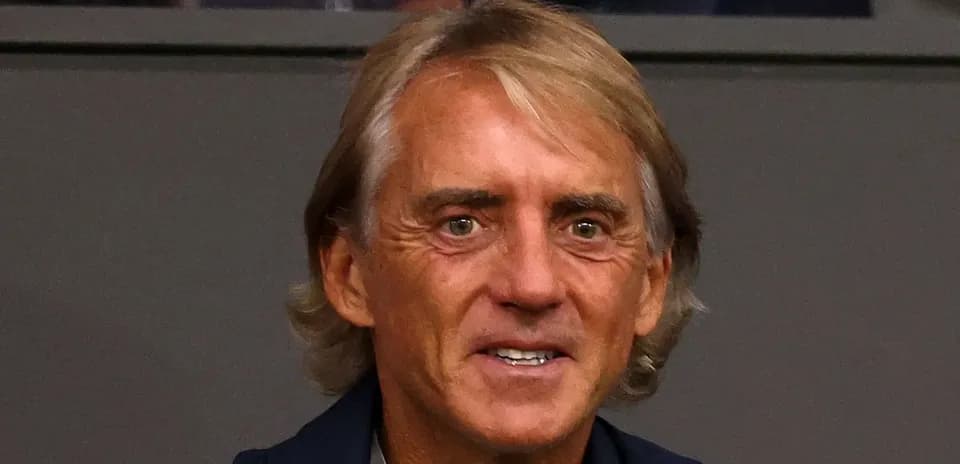Man smiling in a sports venue setting