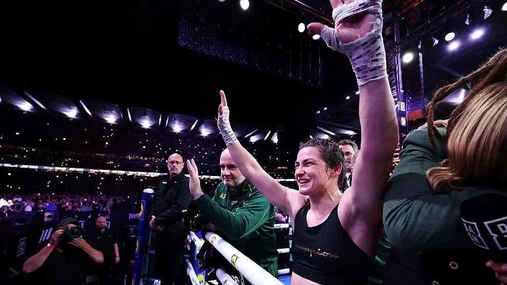 Female boxer celebrating victory in the ring