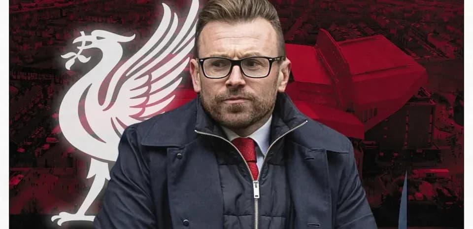 Man in suit with Liverpool FC logo background
