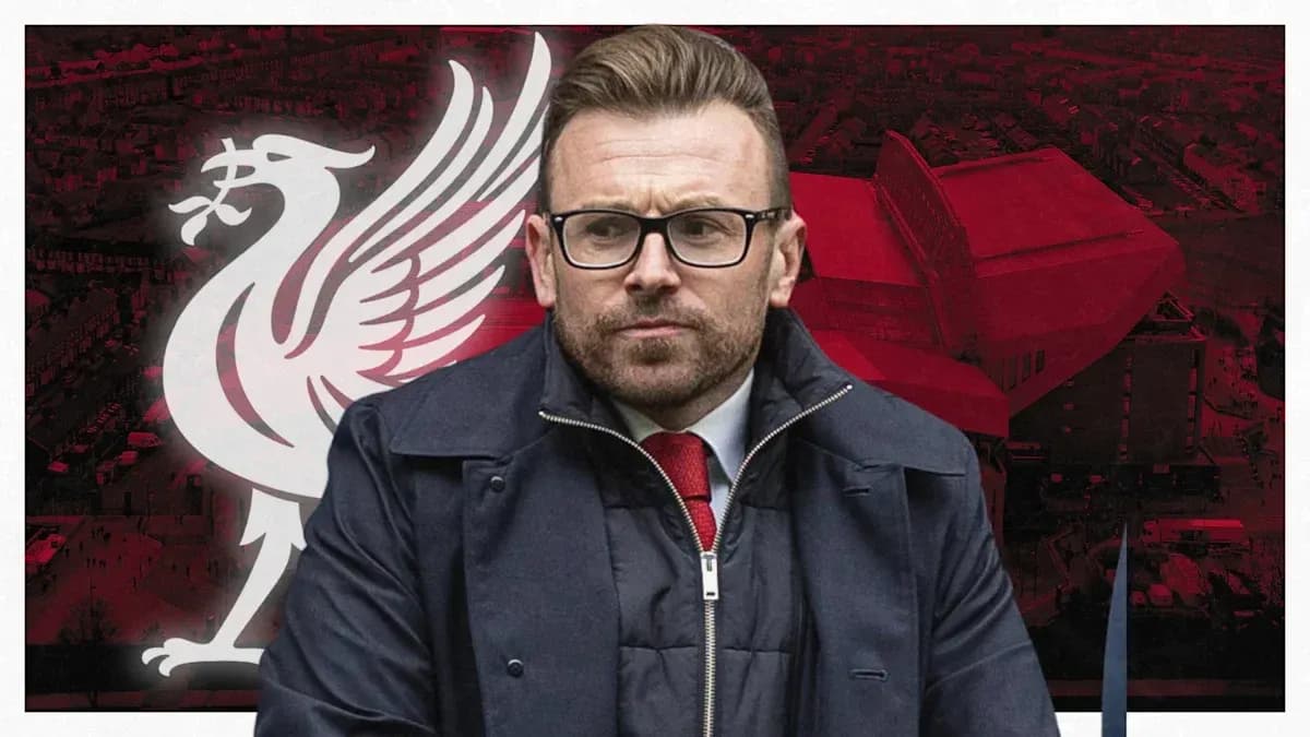 Man in suit with Liverpool FC logo background