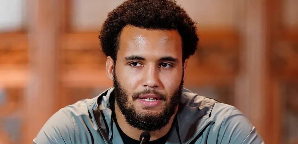 Athlete speaking at press conference podium