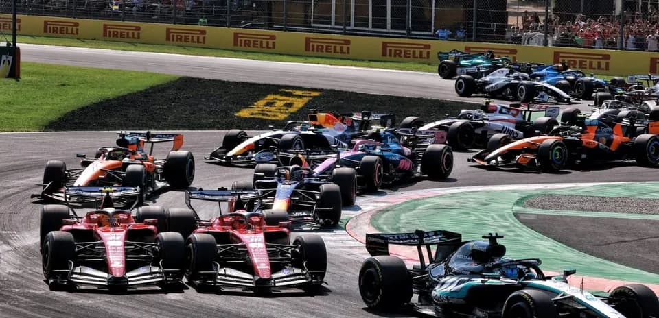 Multiple Formula 1 cars racing through a corner