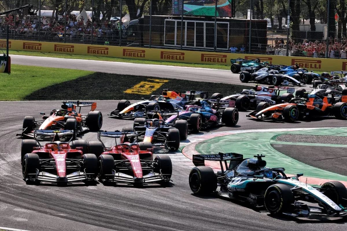Multiple Formula 1 cars racing through a corner