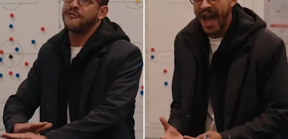 Coach discussing strategy in front of a whiteboard