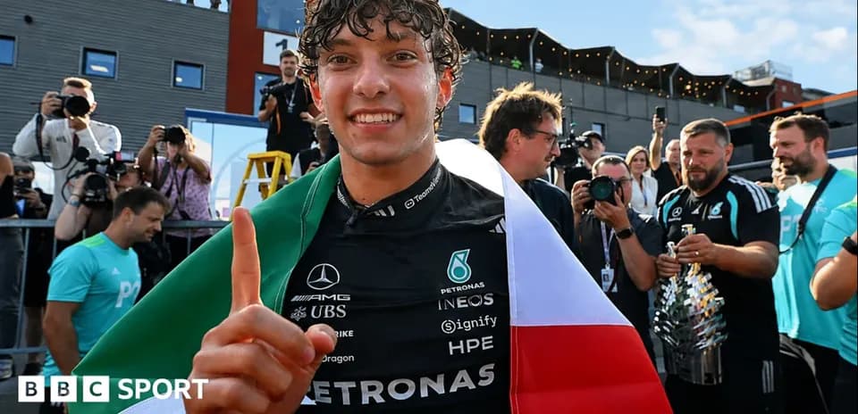 Driver celebrating with flag after race victory