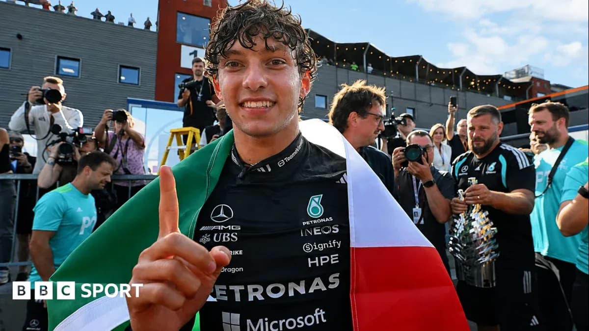 Driver celebrating with flag after race victory