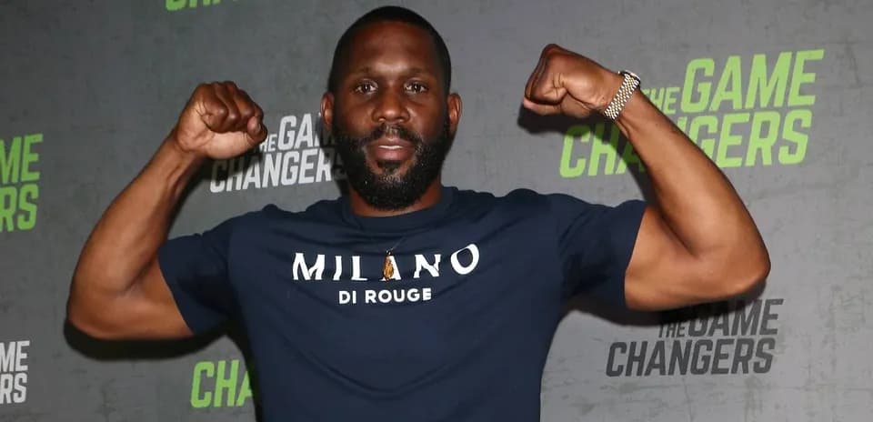 Man flexing muscles at promotional event