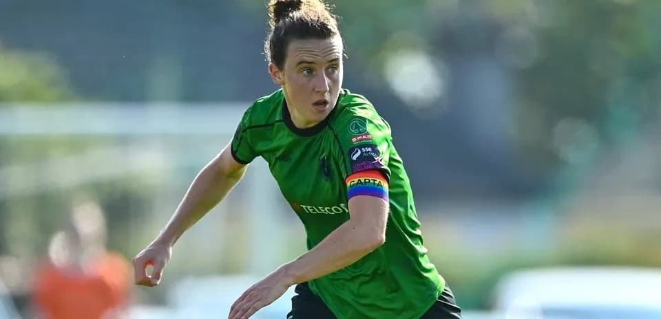 Player in green kit running on the field