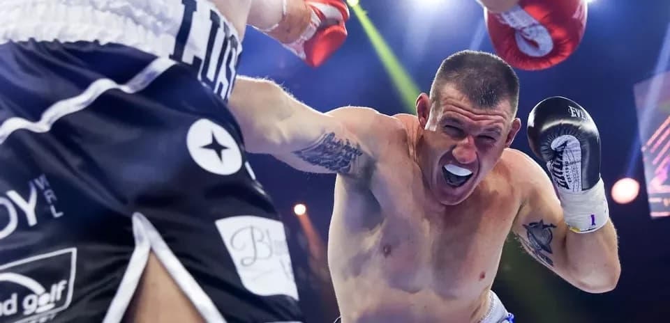 Boxer delivering a punch during a match