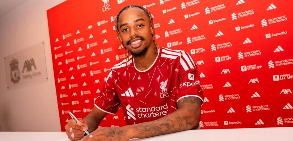 Player signing contract at Liverpool FC announcement event