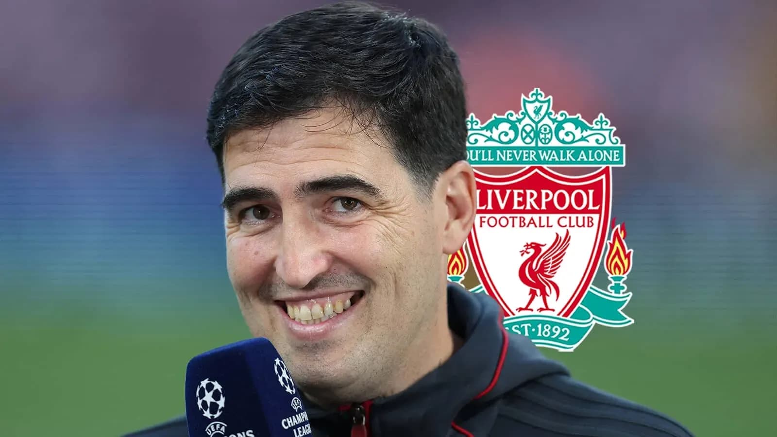 Man smiling with Liverpool FC logo in background