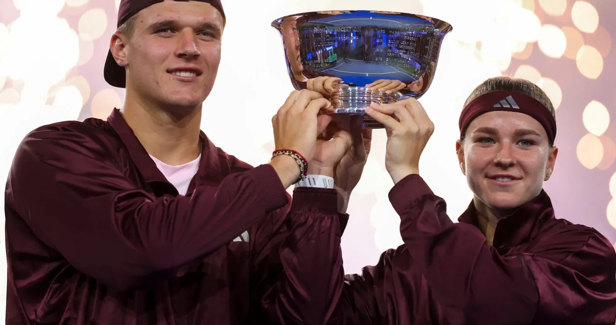 Players celebrating victory with trophy at event