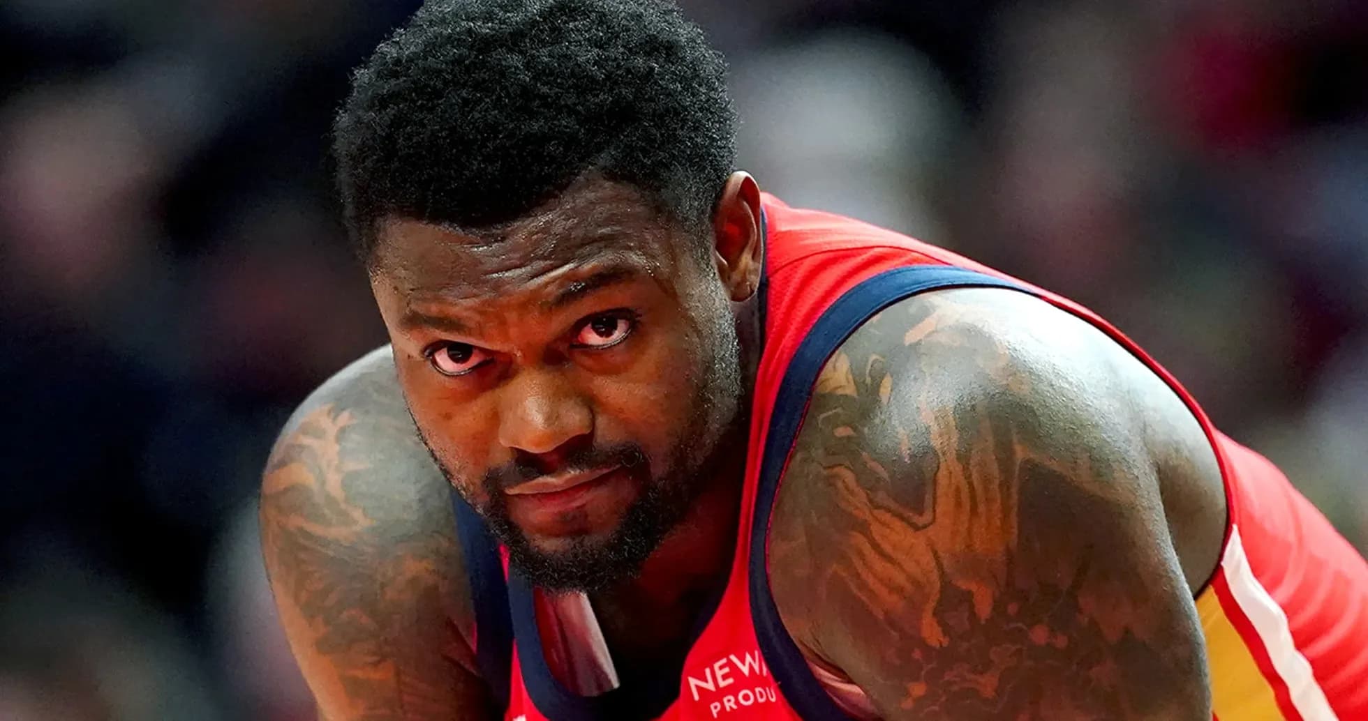 Basketball player in red jersey looking intently
