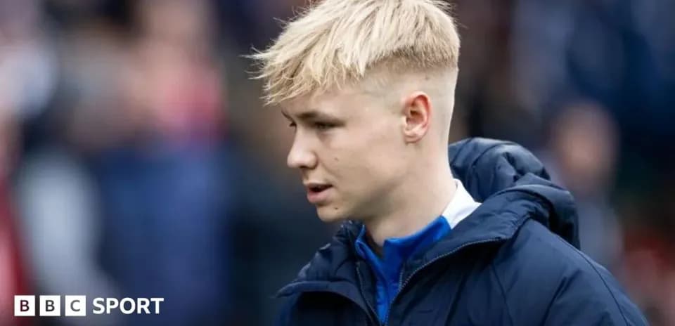 Player in team jacket walking on the pitch