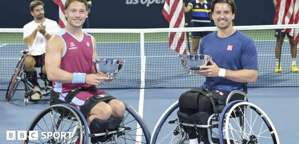 Two wheelchair tennis players holding trophies at US Open