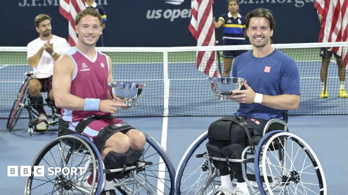 Two wheelchair tennis players holding trophies at US Open