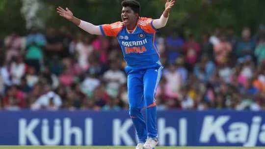 Cricketer appealing during match with crowd in background