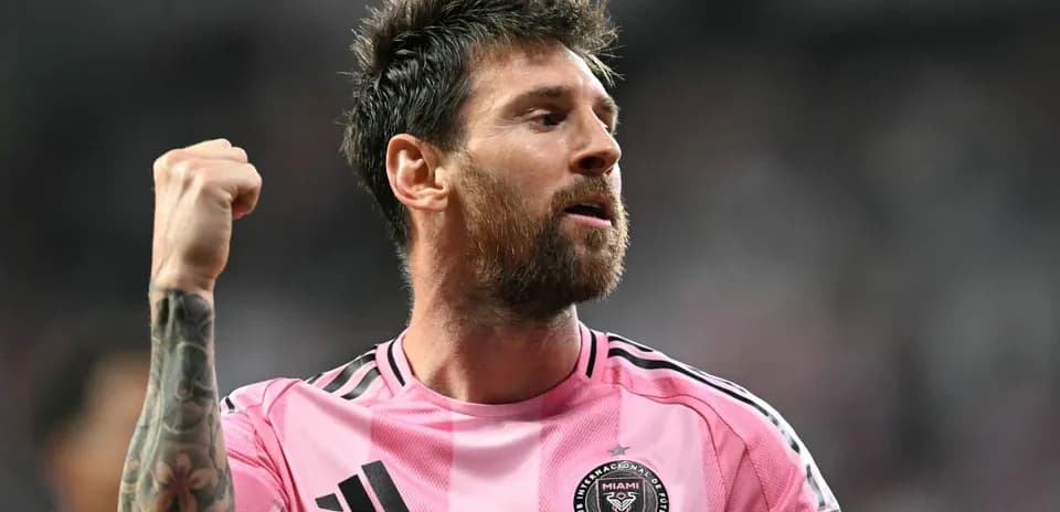 Player celebrating in pink jersey during match