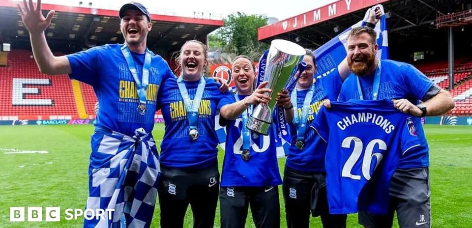 Team celebrating championship win with trophy and banners