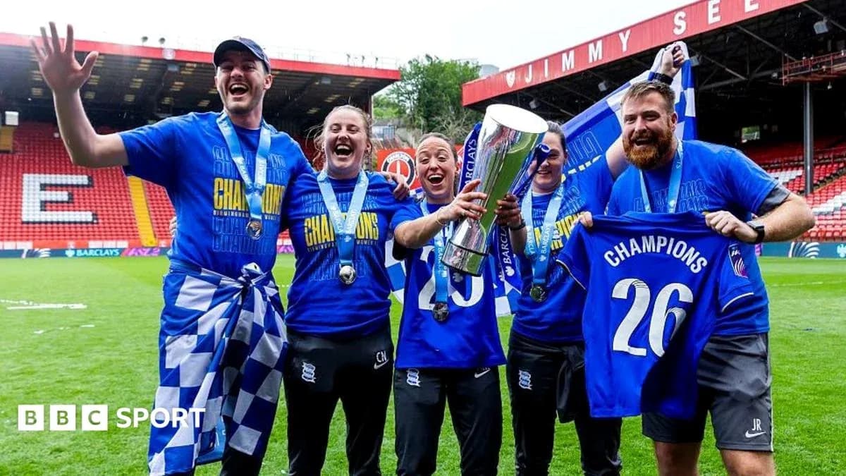 Team celebrating championship win with trophy and banners