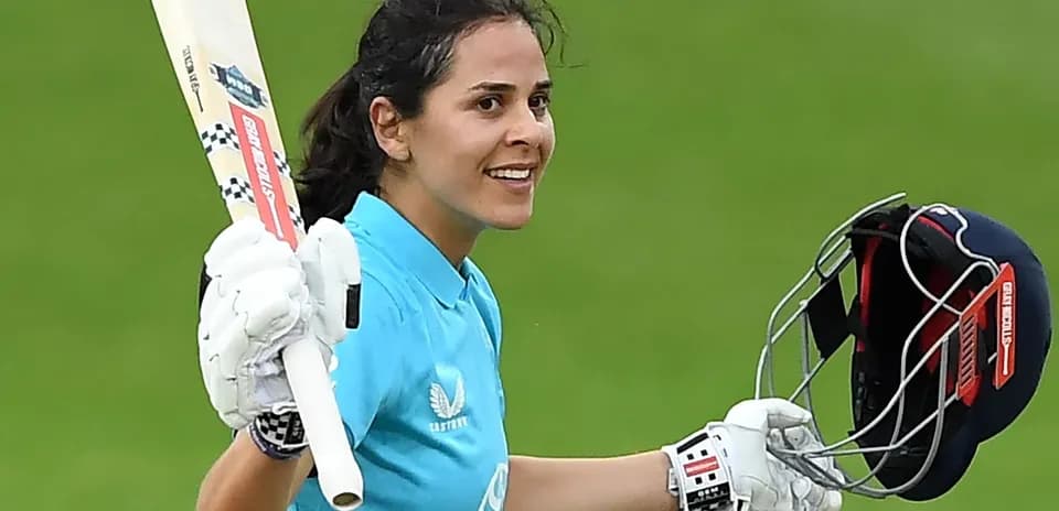Cricketer celebrating with bat after scoring runs