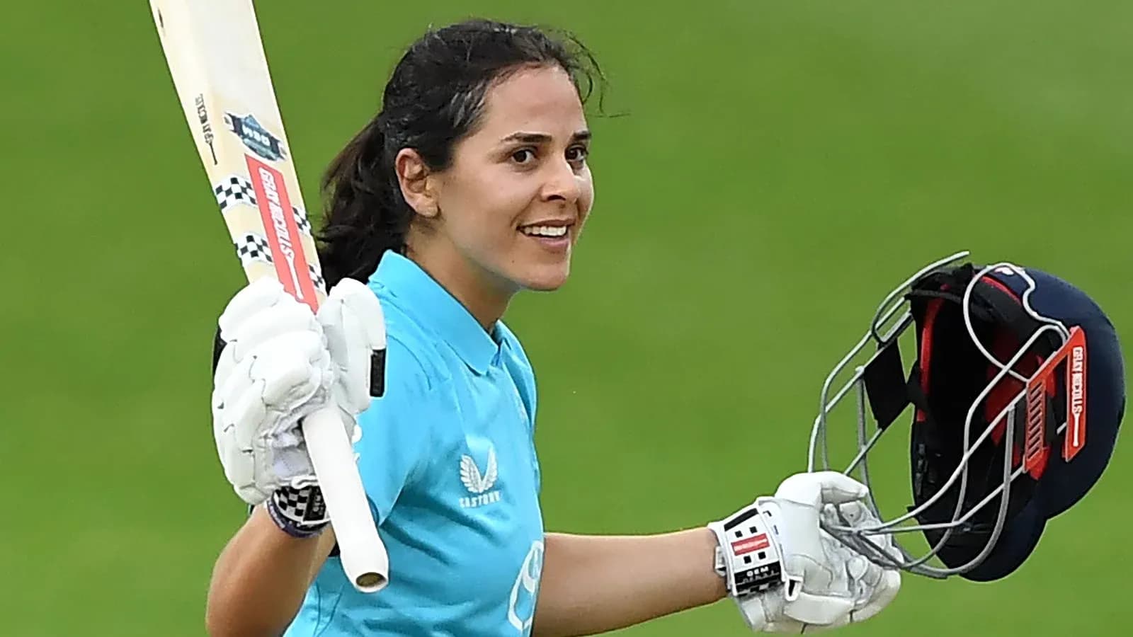 Cricketer celebrating with bat after scoring runs