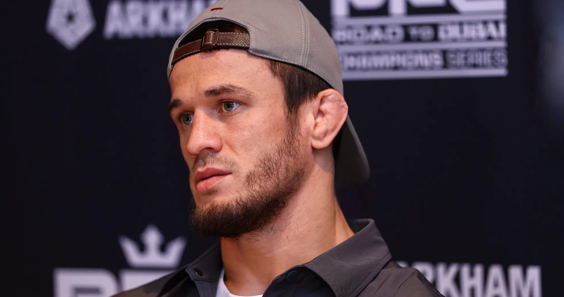Athlete speaking at press conference with cap