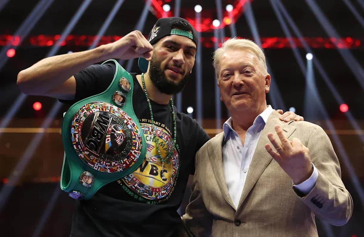 Boxer holding WBC belt with promoter in arena Boxer holding WBC belt with promoter in arena