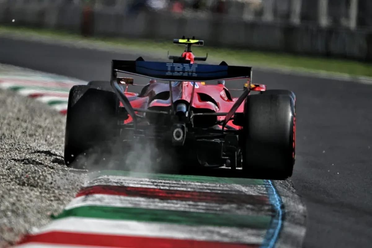 Red Formula 1 car driving on track with smoke Red Formula 1 car driving on track with smoke