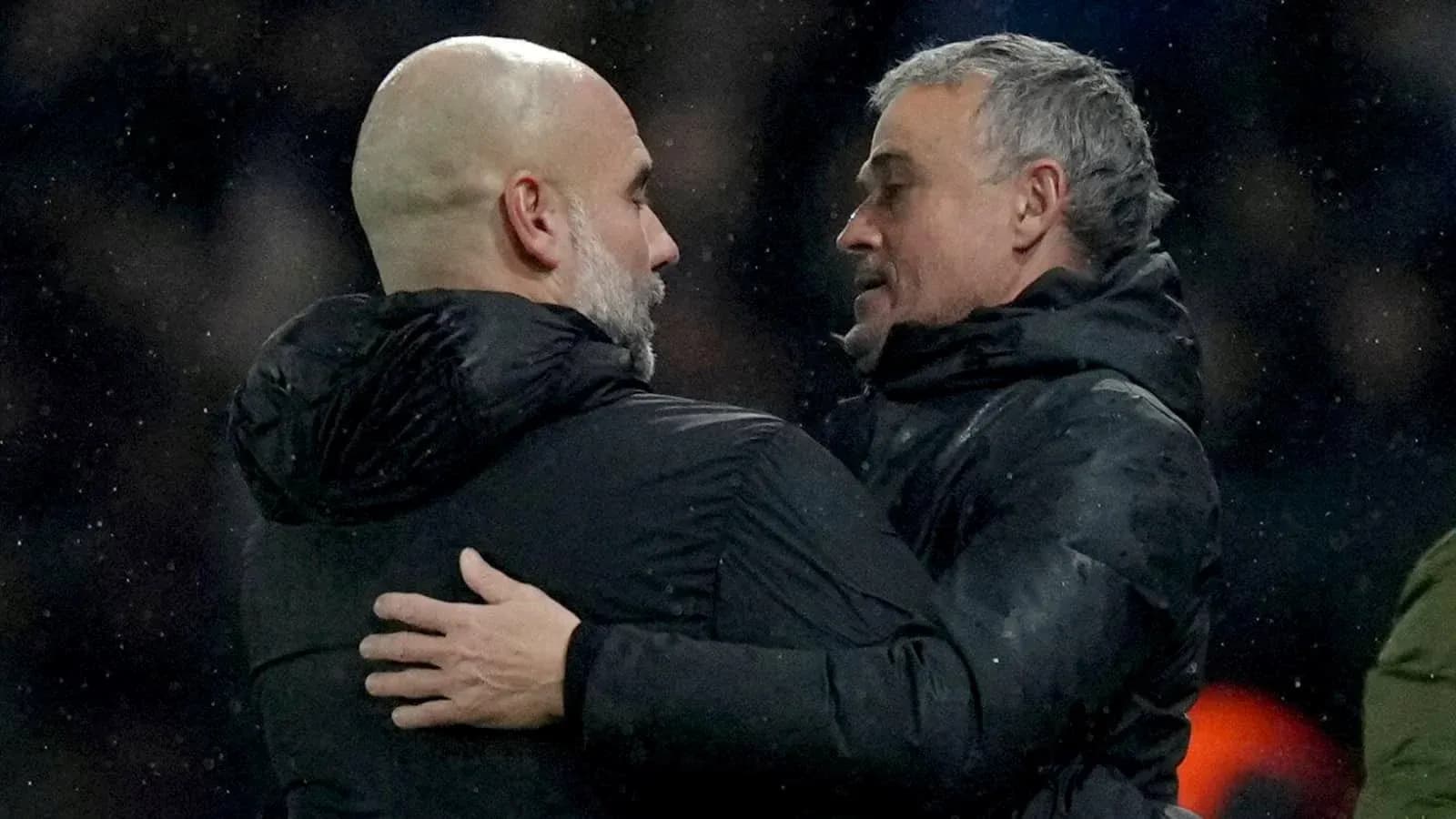 Two coaches embracing on the sidelines after match Two coaches embracing on the sidelines after match