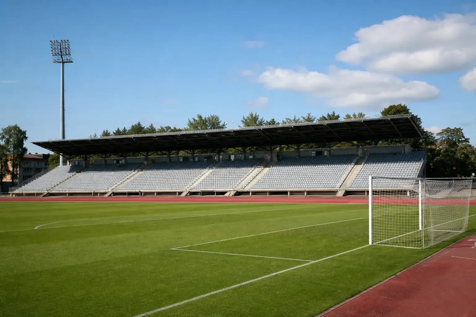 Empty football stadium with seating and goalpost Empty football stadium with seating and goalpost