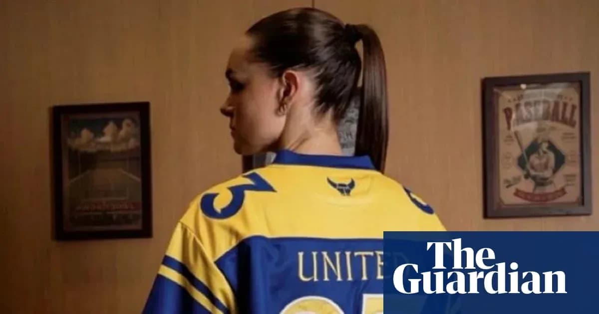 Person wearing a sports jersey with 'UNITED' text Person wearing a sports jersey with 'UNITED' text