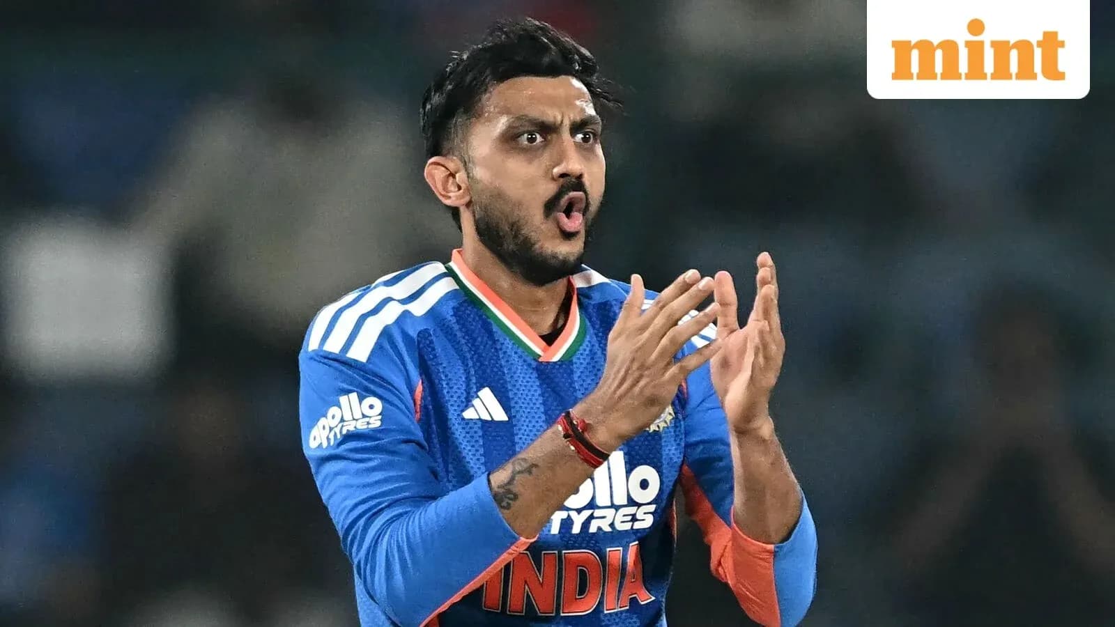 Cricketer celebrating during a match in blue uniform Cricketer celebrating during a match in blue uniform