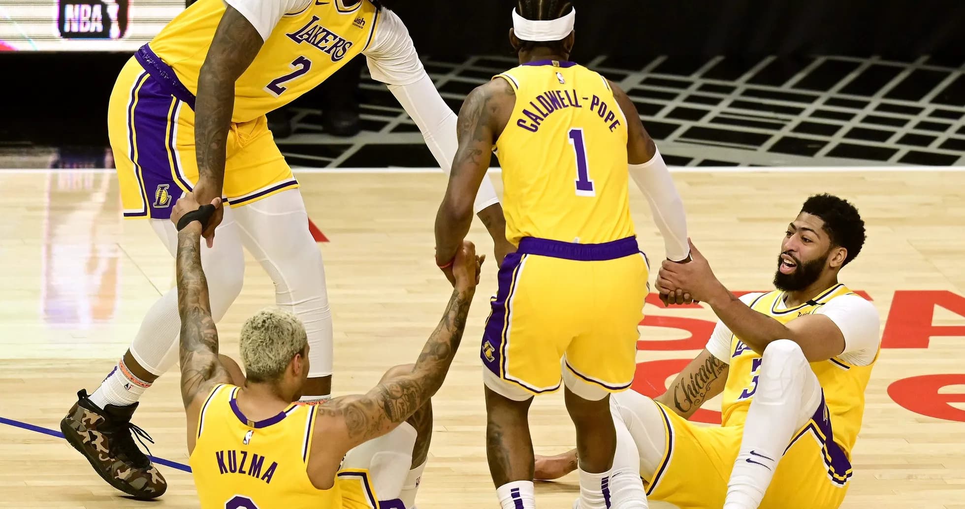 Lakers players helping each other off the court Lakers players helping each other off the court