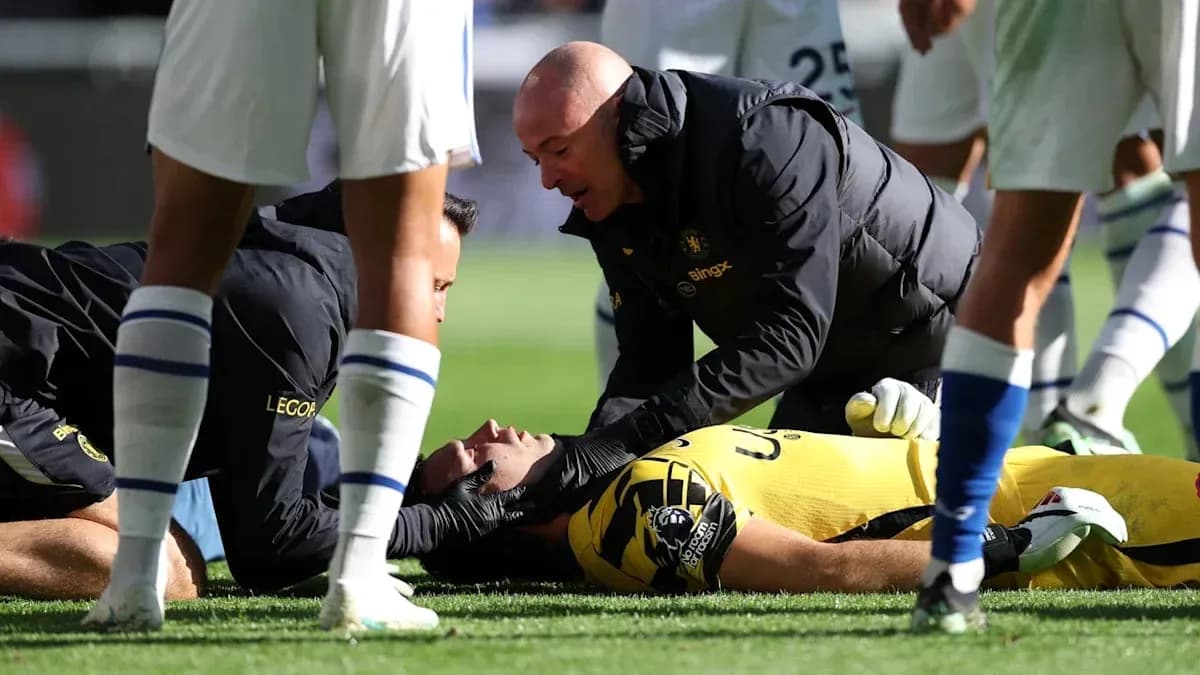 Medical staff attending to injured goalkeeper on field Medical staff attending to injured goalkeeper on field