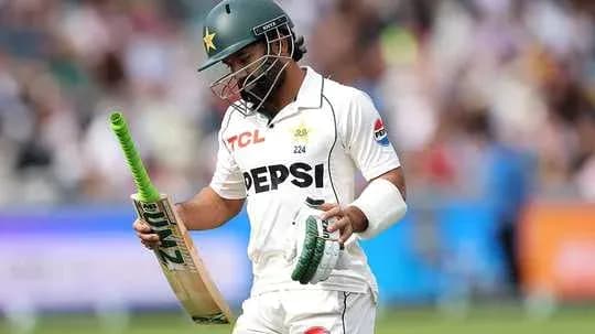 Batsman walking off field with bat in hand Batsman walking off field with bat in hand