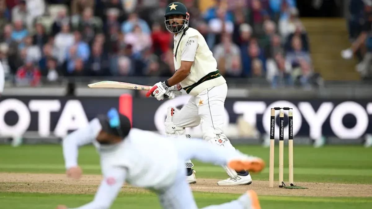 Batsman playing a shot while a fielder dives Batsman playing a shot while a fielder dives