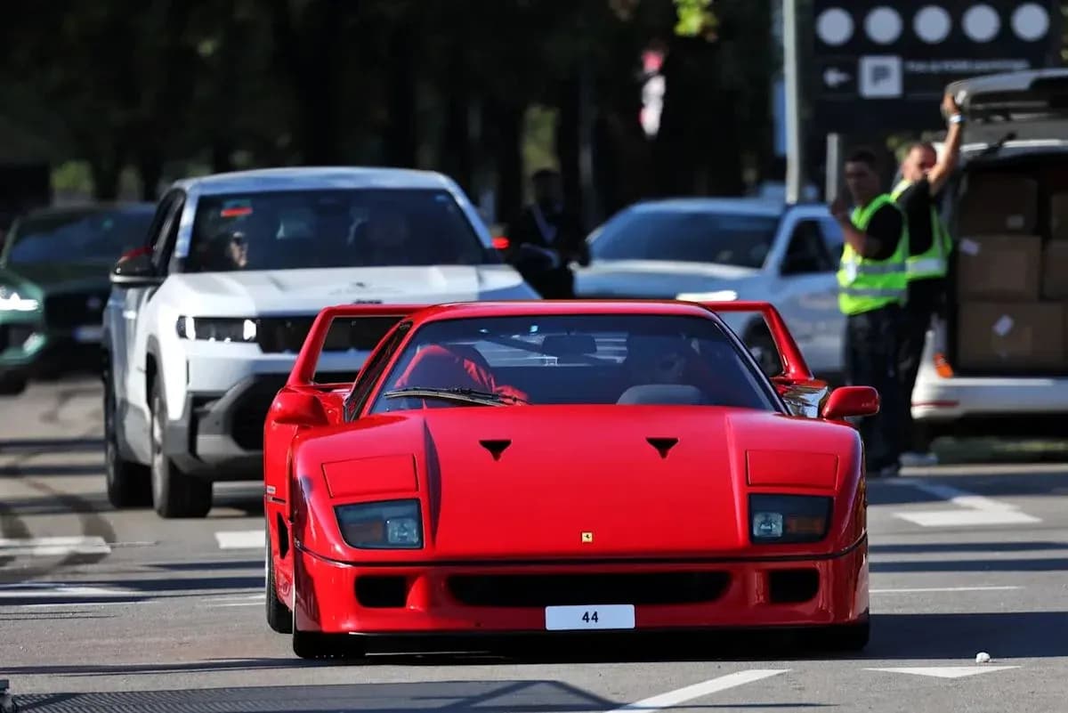 Red Ferrari F40 driving on urban street Red Ferrari F40 driving on urban street