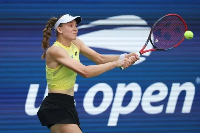 Player hitting a tennis ball during US Open match Player hitting a tennis ball during US Open match