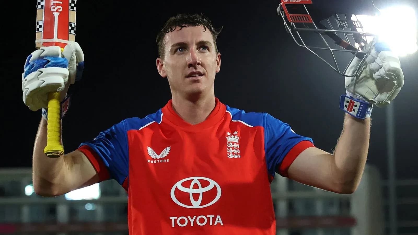 Cricketer celebrating with bat after scoring runs Cricketer celebrating with bat after scoring runs